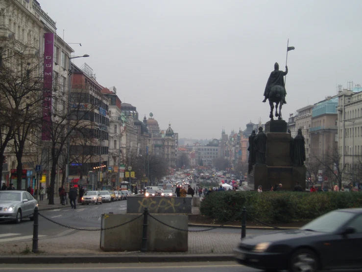 cars and pedestrians are moving down the street