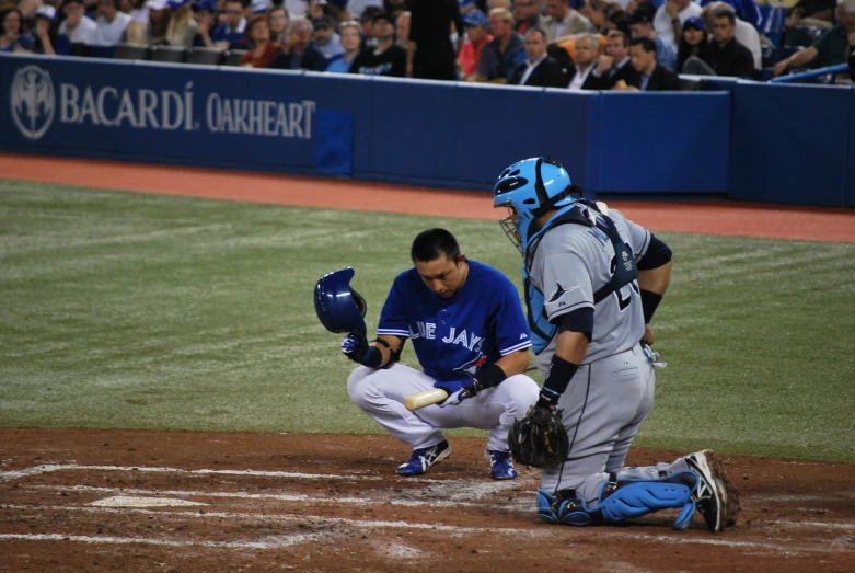 the baseball player is kneeling on the base