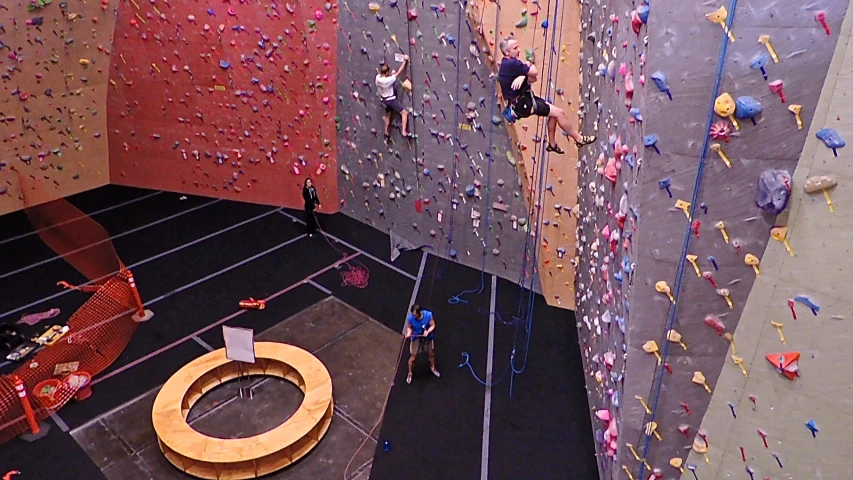 two people on top of rocks, climbing in the gym