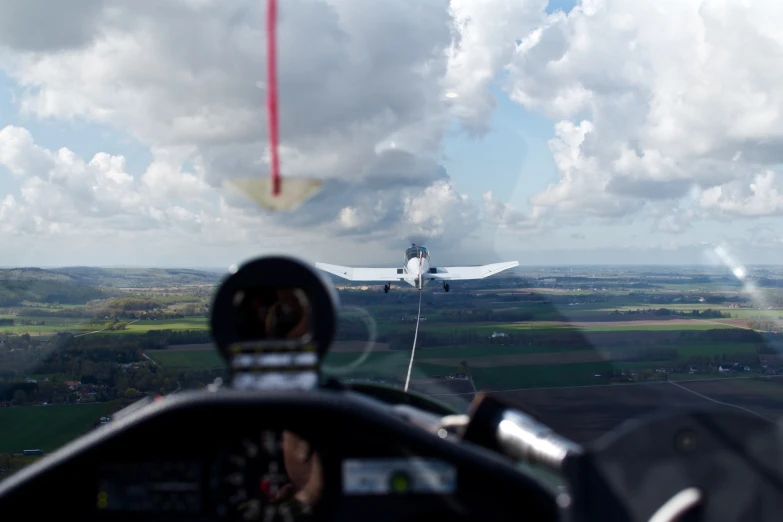 an airplane flying in the air with a sky background