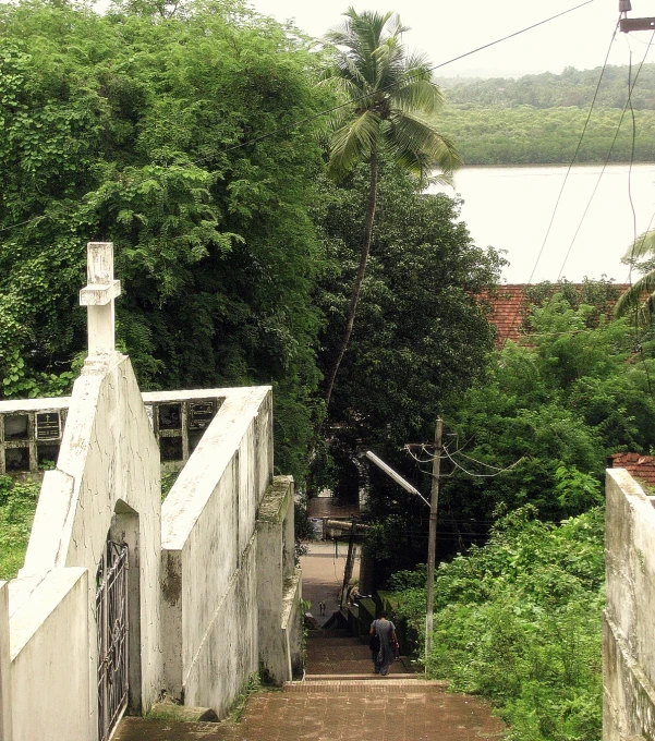 two people walk up the stairs that lead up to the bridge