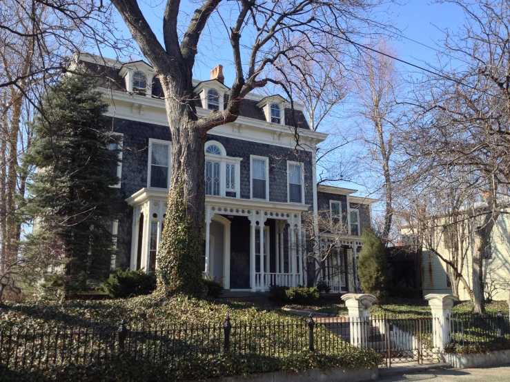 an ornate house sits on the corner of the road