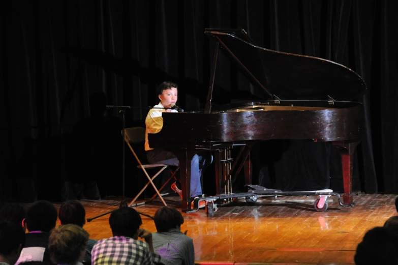 a man in a suit is sitting at a piano