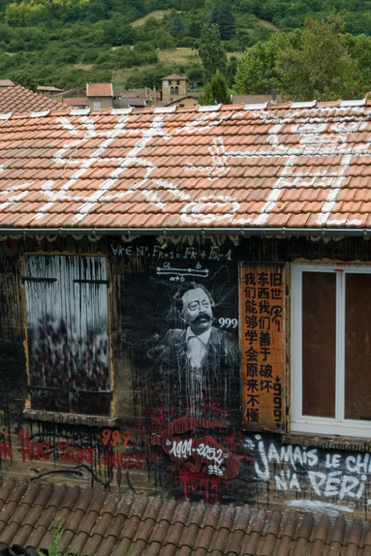 the house is covered in graffiti and has lots of windows