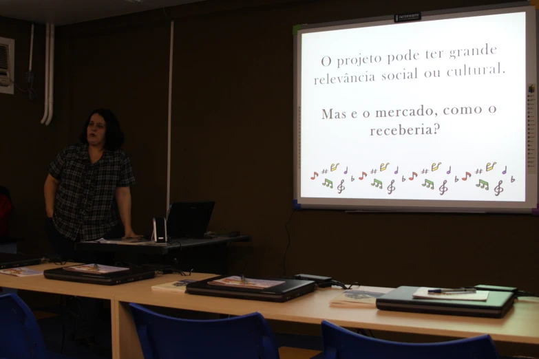 a person standing next to a projector screen