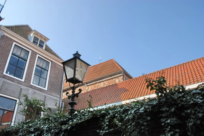 a light pole in front of several brick buildings