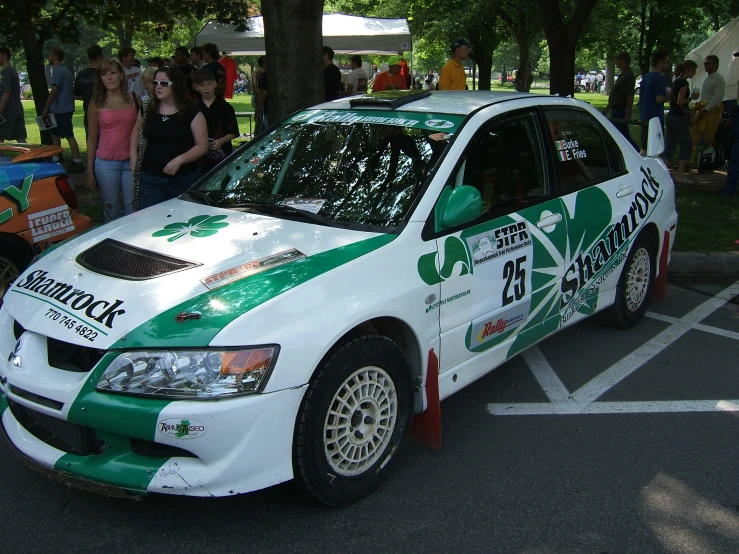 a green and white car parked in the middle of a park