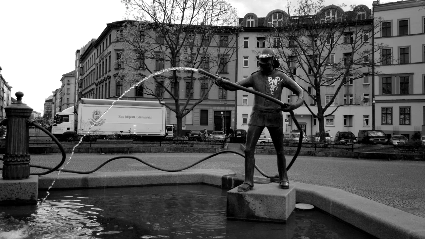 a statue sitting in the middle of a fountain