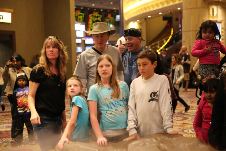 a group of people with children and adults in a mall