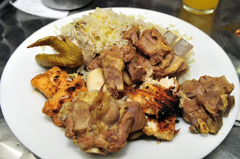 a plate full of food with rice and meat