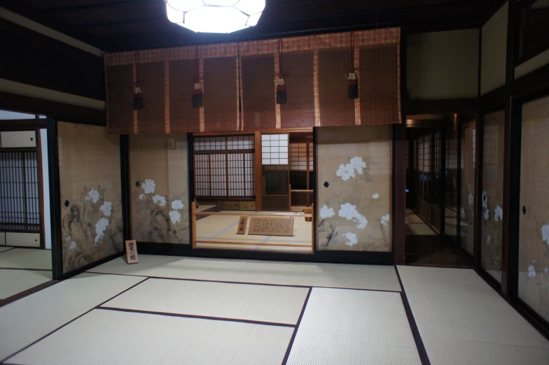 an asian room with tatama mats and a chandelier