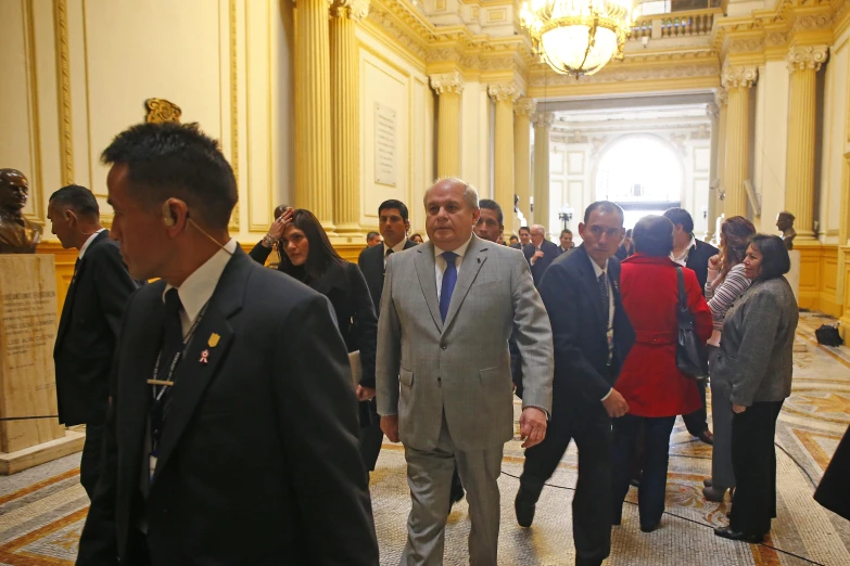 the man is standing next to a large group of people