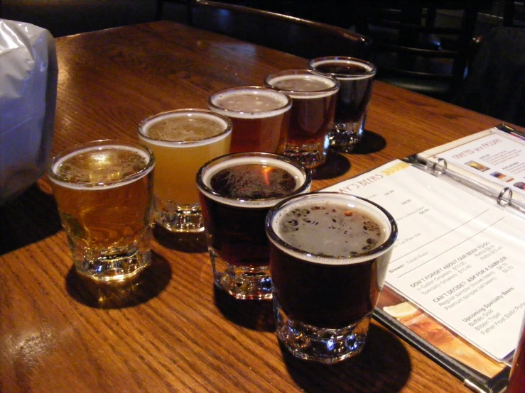 five beers and menus on a table