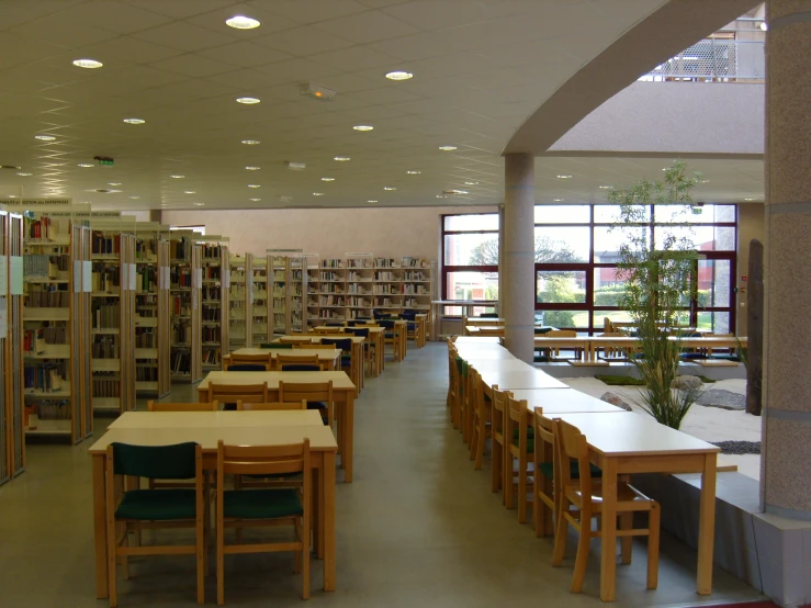 long tables and chairs in a room with books