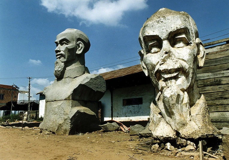 two sculptures of presidents made of rock in front of buildings