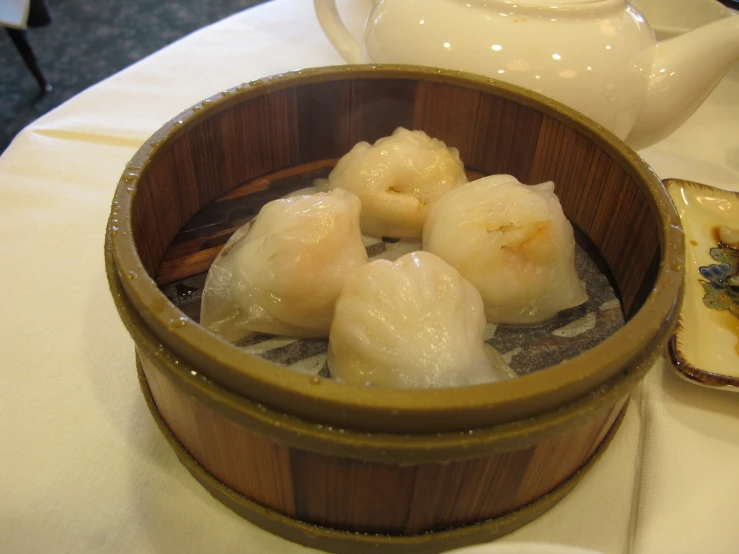 there are small dumplings in a wood container on the table