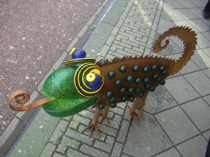 a metal sculpture made to look like a green peacock