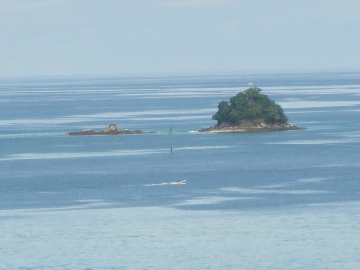an island on an ocean with small trees