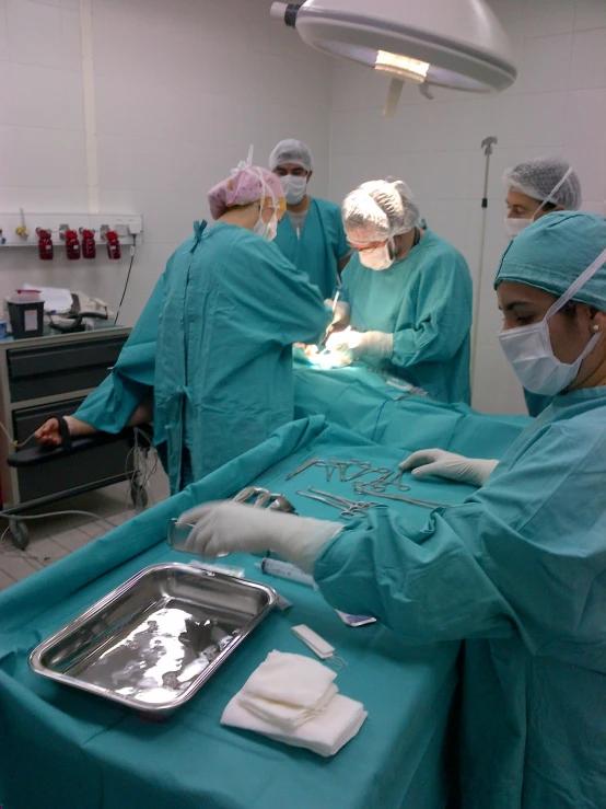 a group of surgeons performing an operation in a hospital