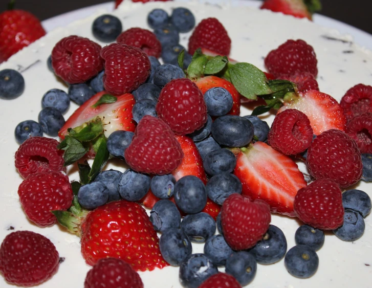 berries, blueberries and raspberries on a white plate