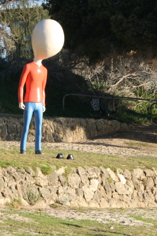 a giant white and orange standing in the grass