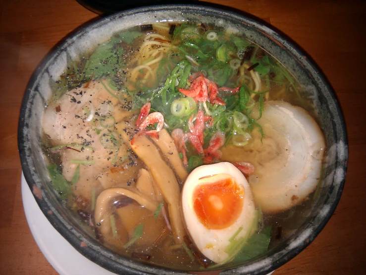 a pot of soup filled with meat and vegetables