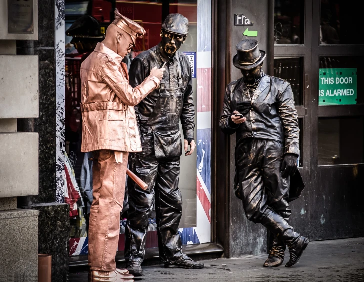 two men stand outside of an store with a guy dressed up