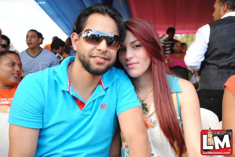 a couple wearing sun glasses and sitting together