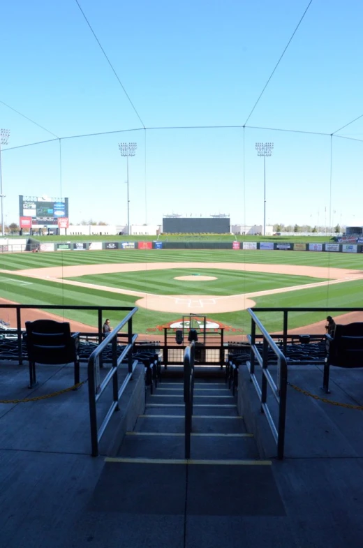 a baseball field is empty with a stairway going up