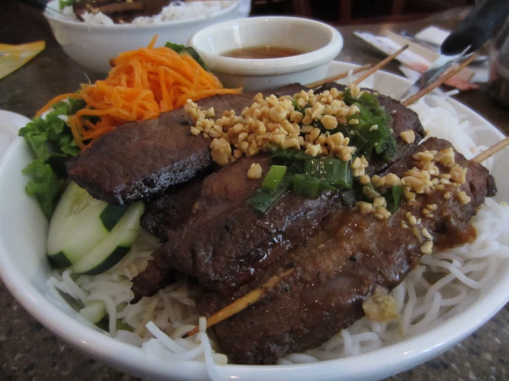 a plate full of beef with vegetables and rice