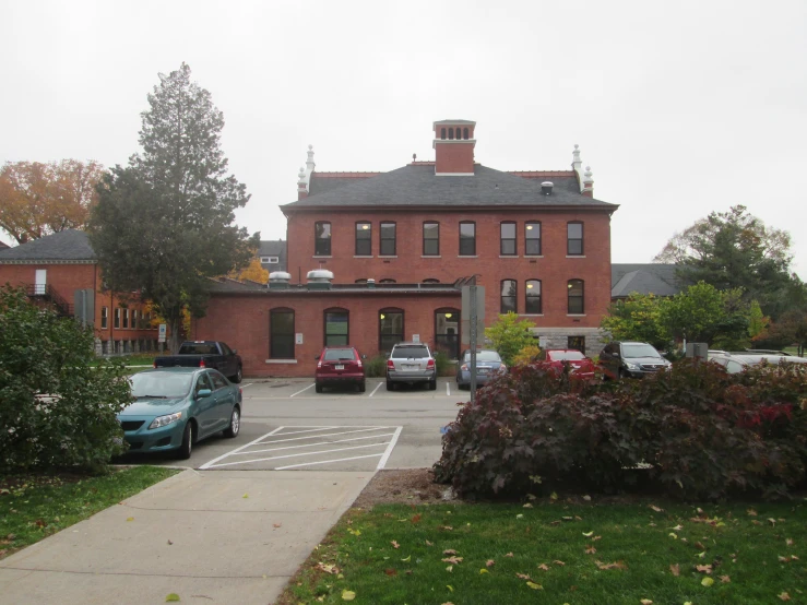 a parking lot is in front of a red brick building