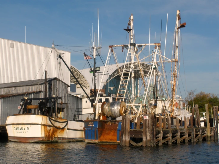 an old boat sitting next to the dock