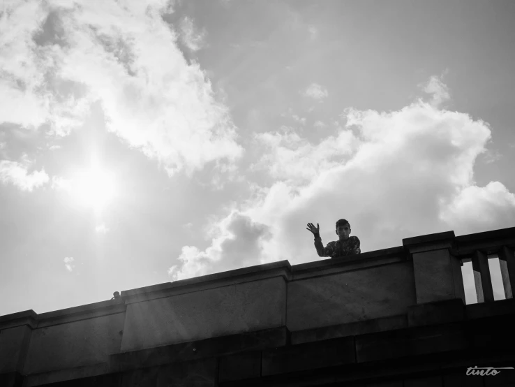 the man is standing on the top of the building