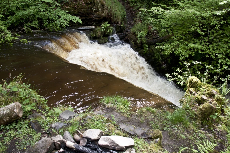 the flowing water was just starting to fall from a hill