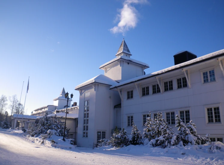 a large building covered with snow on top of a street