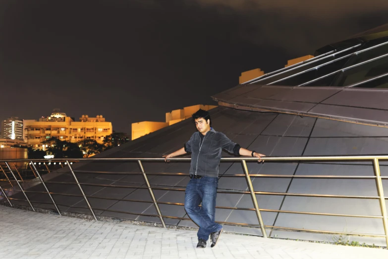 a man posing for the camera by some stairs