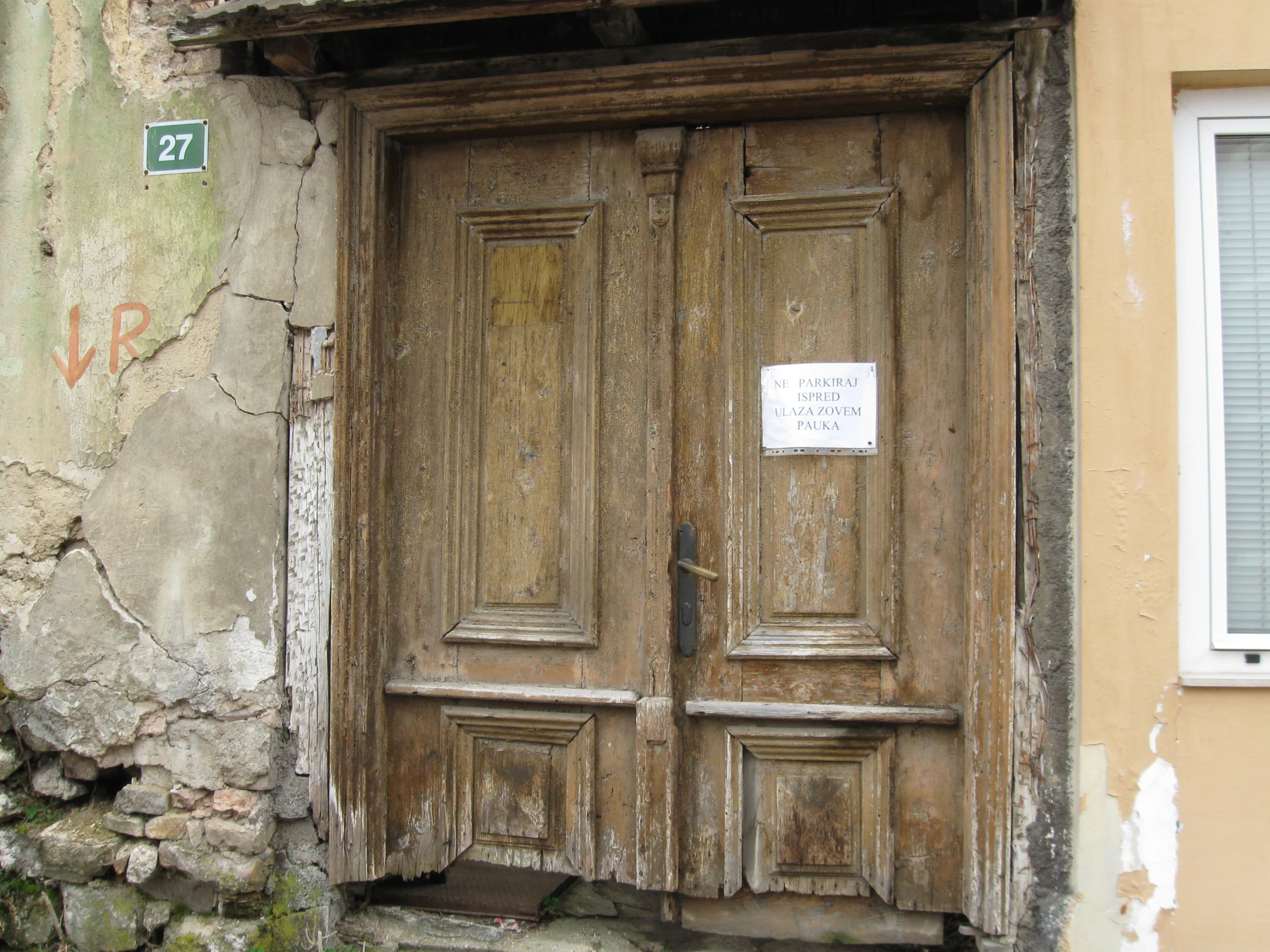 an old wooden door and window of a home