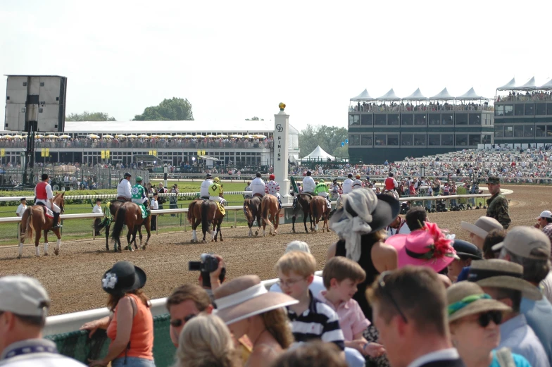 jockeys and their horses race across the track