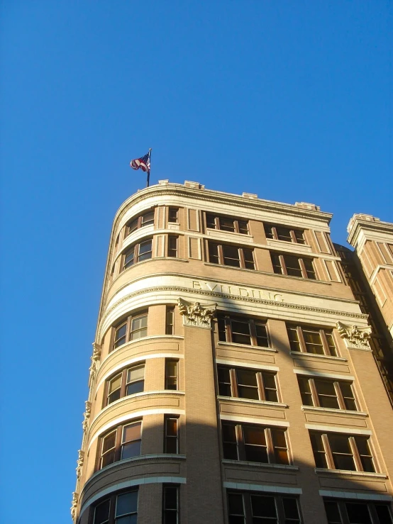 a very tall building in front of a blue sky