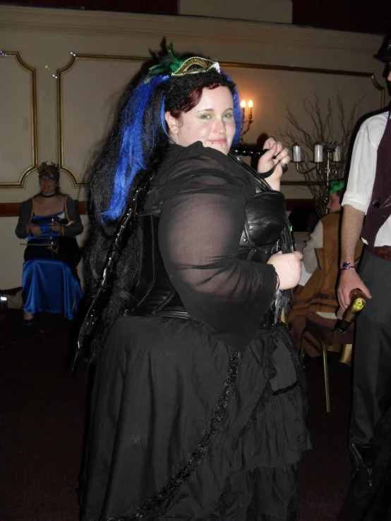 a woman with blue hair in a costume standing in a room