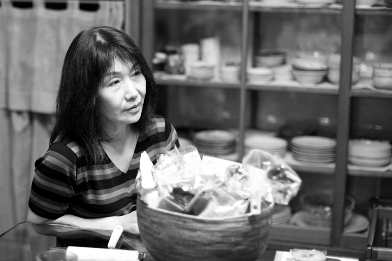 a woman looking over at a basket full of cookies