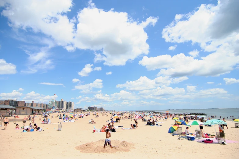 a crowded beach with many people on it