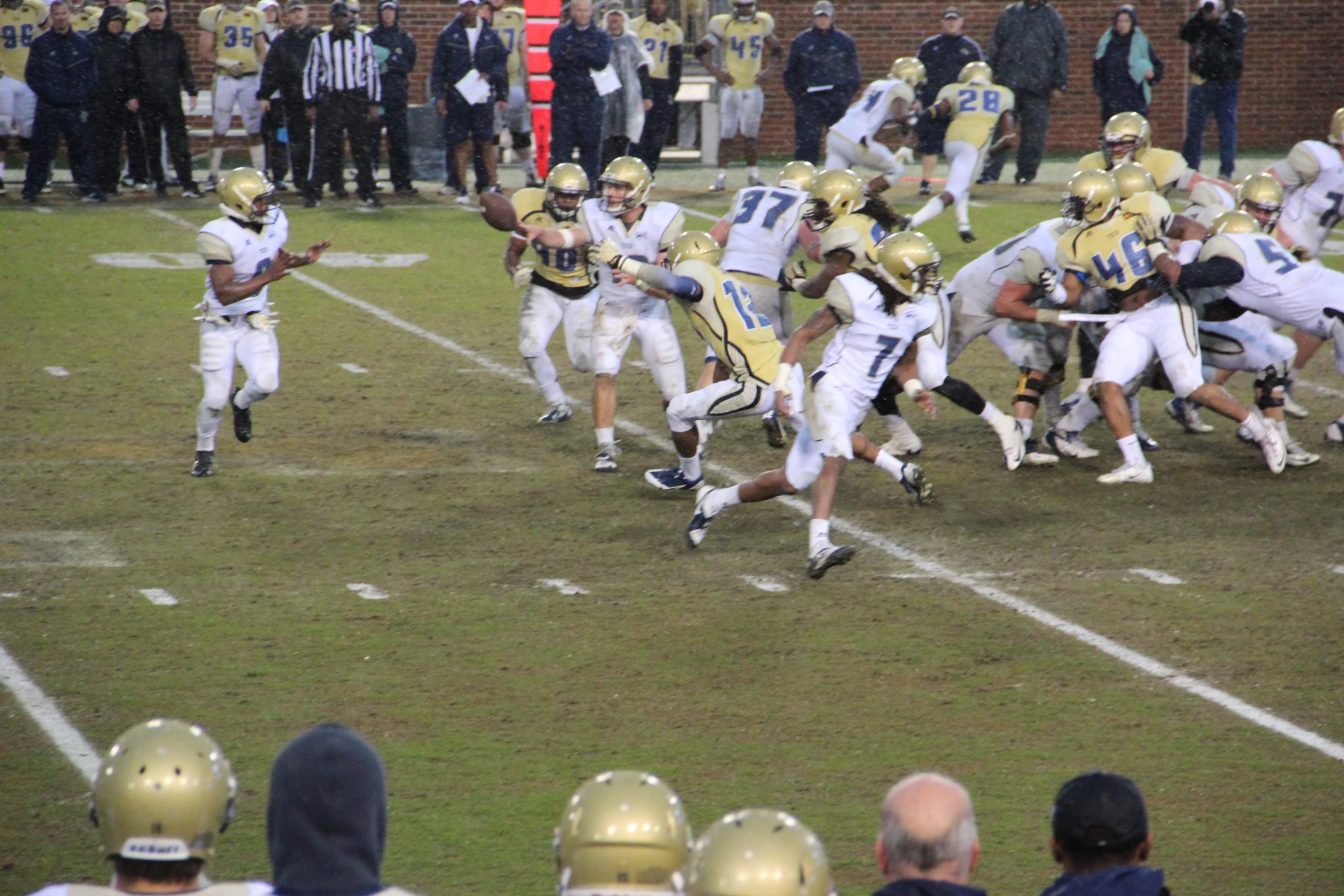 football players running with the ball on the field