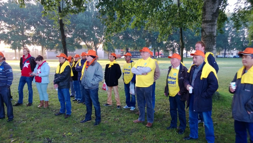 a group of people with hats on and wearing shirts