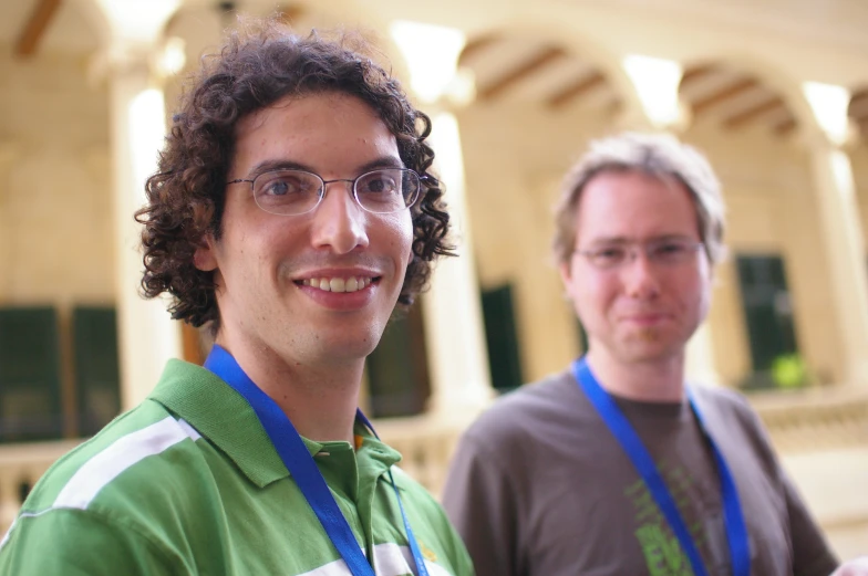 two men standing beside each other with ribbons in hand