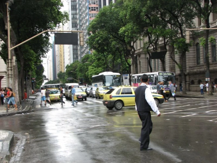 people and buses in traffic on the street