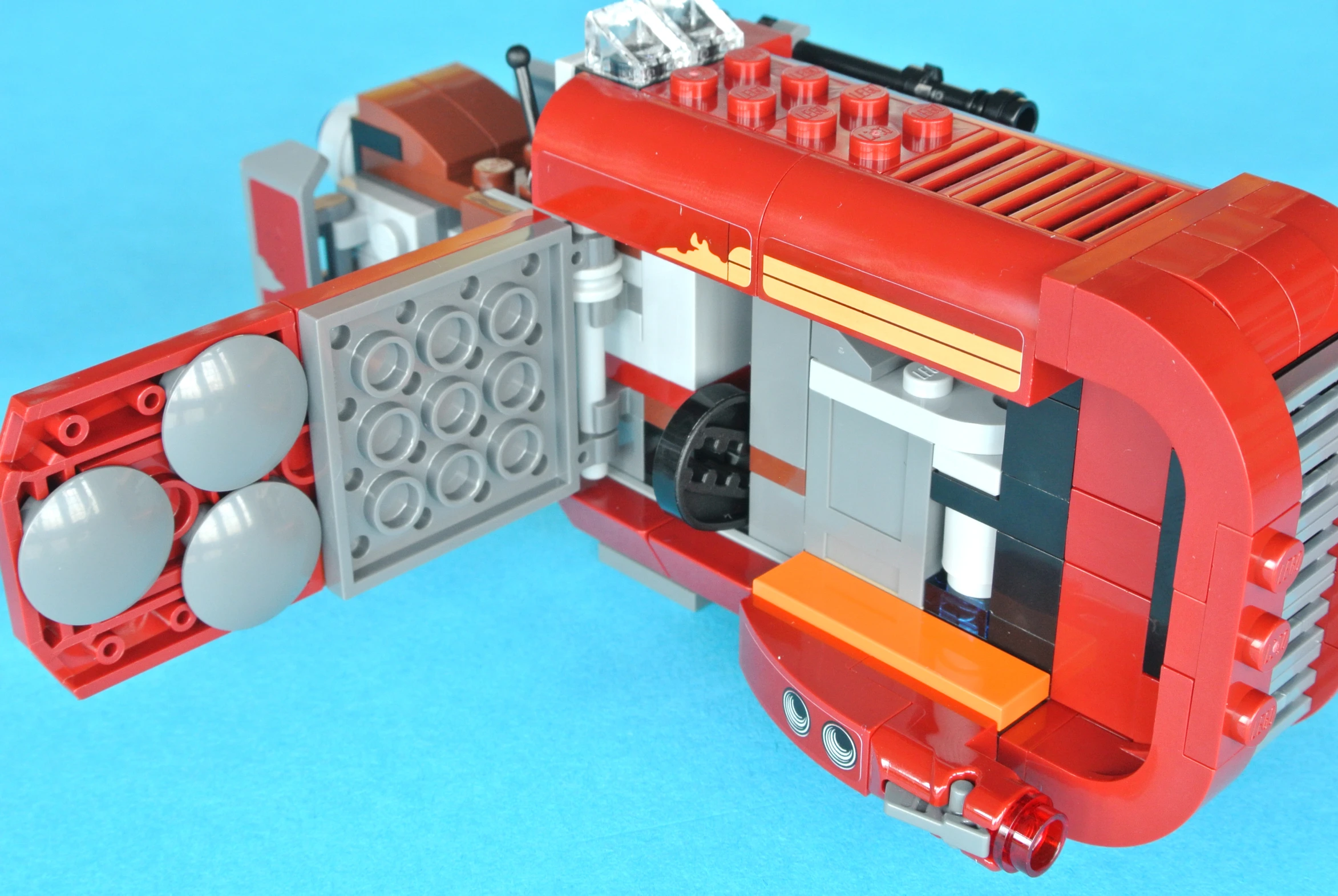 a small lego firetruck with an open door and a fireman's hat