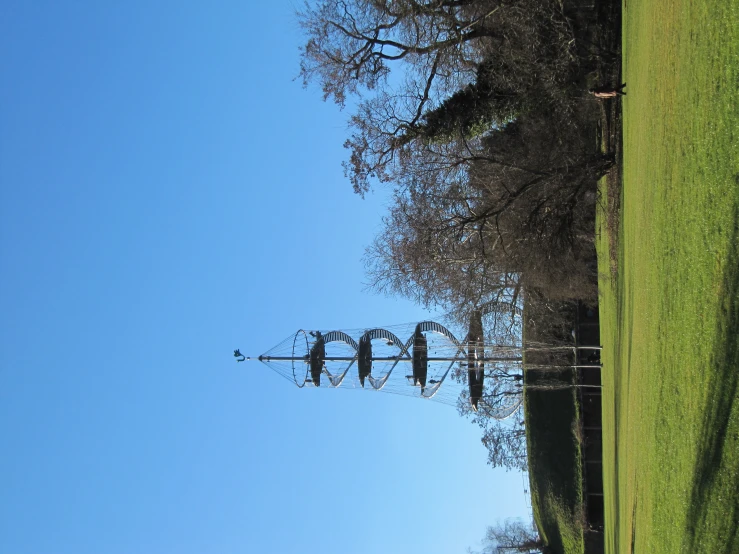 an airplane flying above a park next to a hill