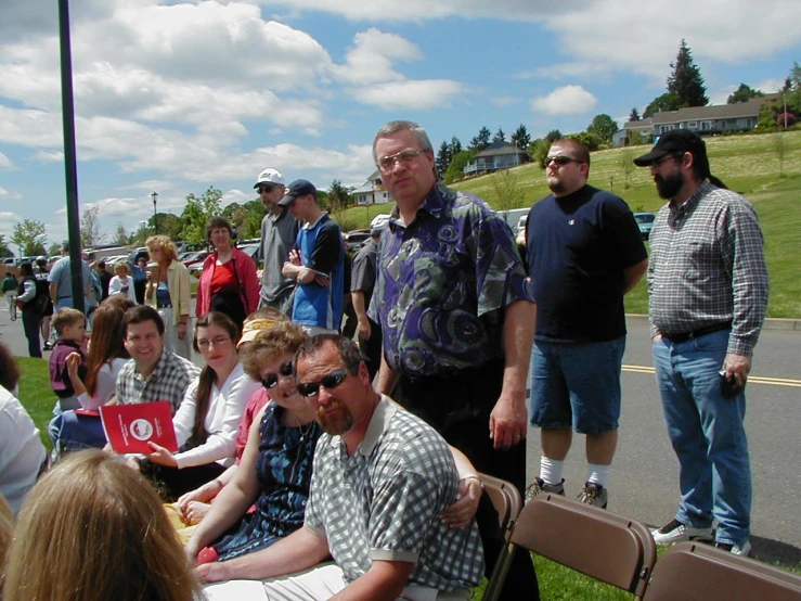 a group of people in a park sitting on benches