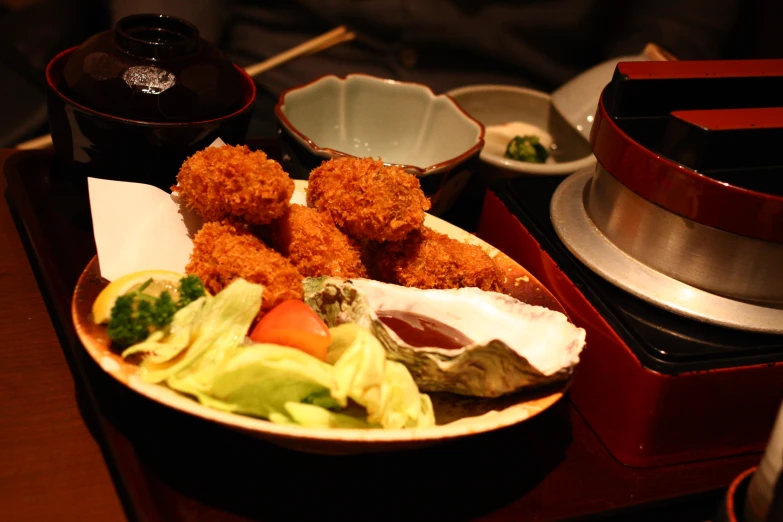 a plate of food with a variety of other foods on a counter